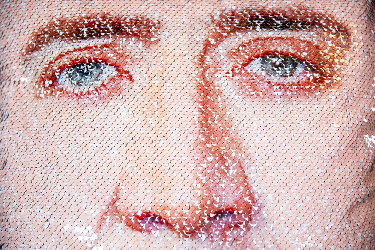A portrait of Cage is printed on a pillow.