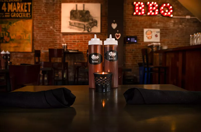 Barbecue sauce sits on a table before dinner service on Wednesday, February 7, 2024. - ZACHARY LINHARES