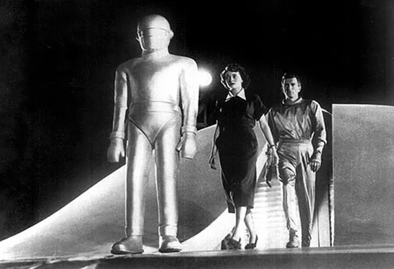 11. The Day the Earth Stood Still (1951) All of Washington, D.C., is thrown into a panic when an extraterrestrial spacecraft lands near the White House. Out steps Klaatu (Michael Rennie, in a role intended for Claude Rains), a handsome and soft-spoken interplanetary traveler, whose bodyguard is Gort (Lock Martin), a huge robot who spews forth laser-like death rays when danger threatens. After being wounded by an overzealous soldier, Klaatu announces that he has a message of the gravest importance for all humankind, which he will deliver only when all the leaders of all nations will agree to meet with him. World politics being what they are in 1951, Klaatu's demands are turned down and he is ordered to remain in the hospital, where his wounds are being tended. Klaatu escapes, taking refuge in a boarding house, where he poses as one Mr. Carpenter (one of the film's many parallels between Klaatu and Christ). There the benign alien gains the confidence of a lovely widow (Patricia Neal) and her son, Bobby (Billy Gray), neither of whom tumble to his other-worldly origins, and seeks out the gentleman whom Bobby regards as the smartest man in the world -- an Einstein-like scientist, Dr. Barnhardt (Sam Jaffe). The next day, at precisely 12 o'clock, Klaatu arranges for the world to stand still -- he shuts down all electrical power in the world, with the exception of essentials like hospitals and planes in flight. Directed by Robert Wise, who edited Citizen Kane (1941) and The Magnificent Ambersons (1942) for director Orson Welles before going on to direct such major 1960s musicals as West Side Story (1961) and The Sound of Music (1965), The Day the Earth Stood Still was based on the story "Farewell to the Master" by Harry Bates. -- Hal Erickson