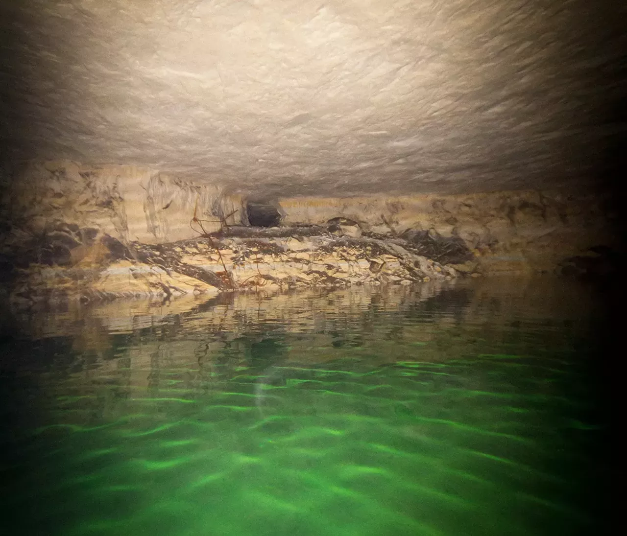 A hole was drilled in one of the underground pillars that support the mountain above the mine. Wiring and pipes were routed through the hole when the mine was operational.