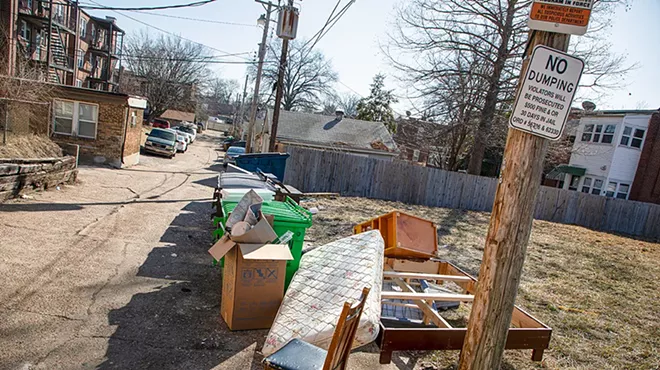 Trash lines the alley behind an apartment complex Cuong Q. Tran owns on Neosho Street.