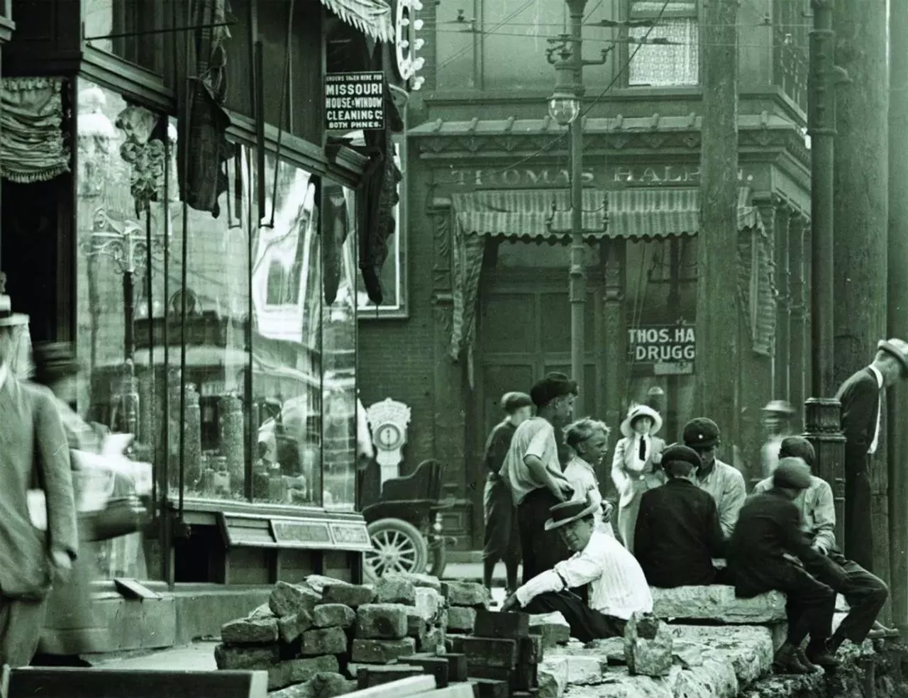 Bystanders observing street construction at the intersection of Grand Avenue and Olive Street. Photograph, ca. 1907.