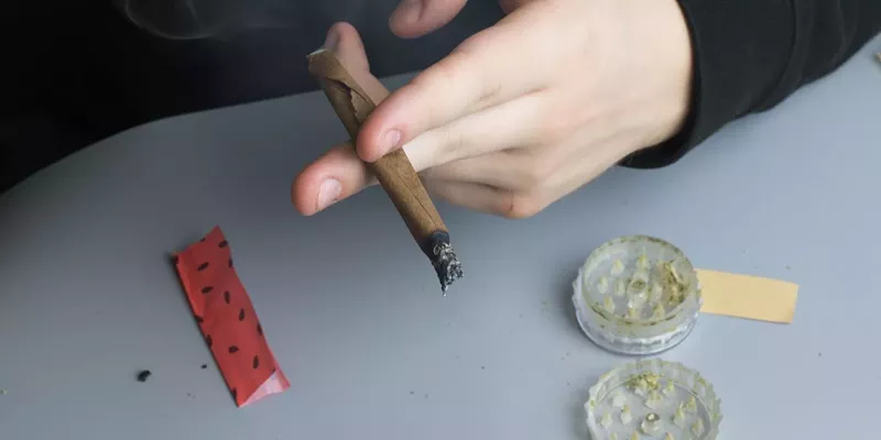 Person getting ready to smoke, emphasizing the importance of identifying contaminated weed.