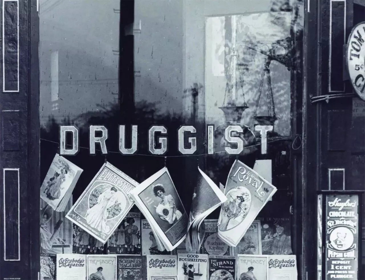 Magazines on display in the storefront window of the M.C. Kalis Drugstore at 4878 Easton Avenue. Photograph, 1906.