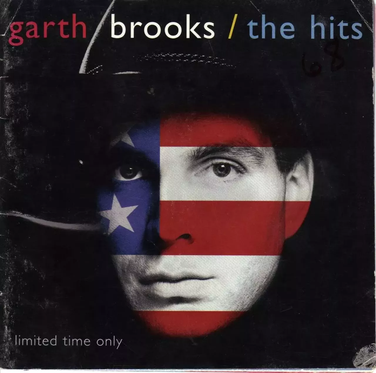Garth Brooks - The Hits (1994) 1994's The Hits has Garth Brooks' face covered in the colors of the American flag and honestly, it's a little creepy. He looks a little like an alien, with those wide-open unblinking eyes. Conversely, the songs on this record -- "Friends in Low Places" -- have become downright iconic in country bars and un-air-conditioned gas stations across the South.
