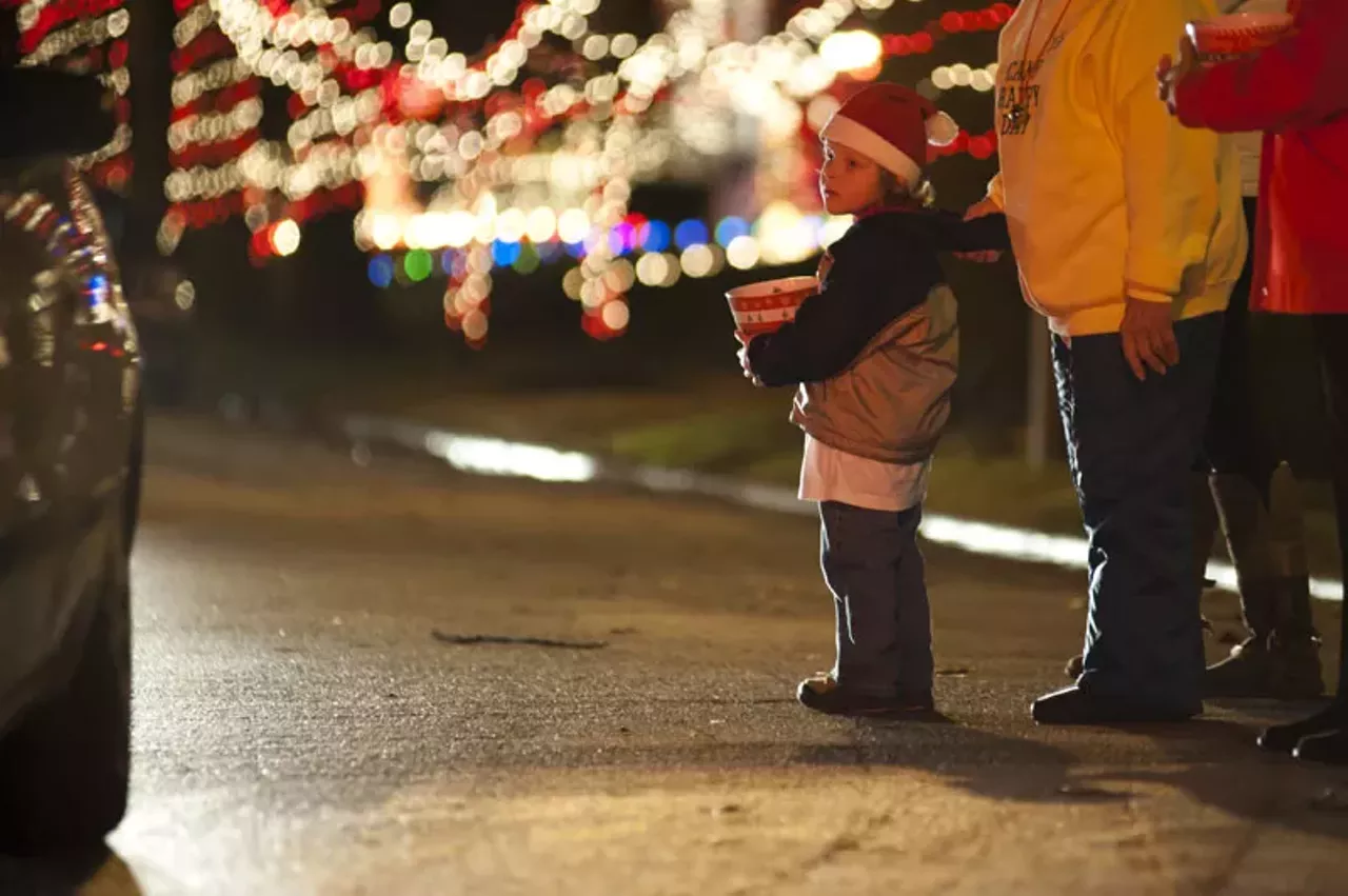 Tyler Kern, 5, watches as cars pass through "Candy Cane Lane." Kern helped collect donations on Wednesday night for Happy Camp Day.