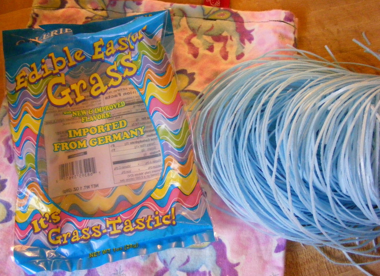 The Worst Edible Easter Grass When edible Easter grass hit the American market, Gut Check was intrigued. We've seldom met a sugary goody we didn't like. Alas, edible Easter grass doesn't even contain sugar. It's sweetened with aspartame, perhaps so that the grass doesn't become sticky in humid conditions. The other main ingredients are potato and corn starches. The resulting texture is like munching away at a foam carry-out container, and the bland, faintly sweet taste is equally disappointing. The vaguely green-apple flavor quickly faded, and as we chewed and chewed and chewed, suddenly the realization hit us: Edible Easter grass tastes like a wad of Communion hosts. While the paschal relevance of Communion hosts to Easter morning is appropriate, Gut Check was brought up never to chew the host. All in all, Gut Check will be sticking with traditional shredded plastic Easter grass, which has several important functions. First, it lessens the burden on parents' wallets. Fill that basket with enough shredded plastic and little darlings might not notice that you shortchanged them in the candy department. Second, no kid will get high on plastic Easter grass. And finally, plastic Easter grass offers a delight found nowhere else -- that moment next Easter when you find a year-old jelly bean nestled in the grass while dragging it out of the basement next year.