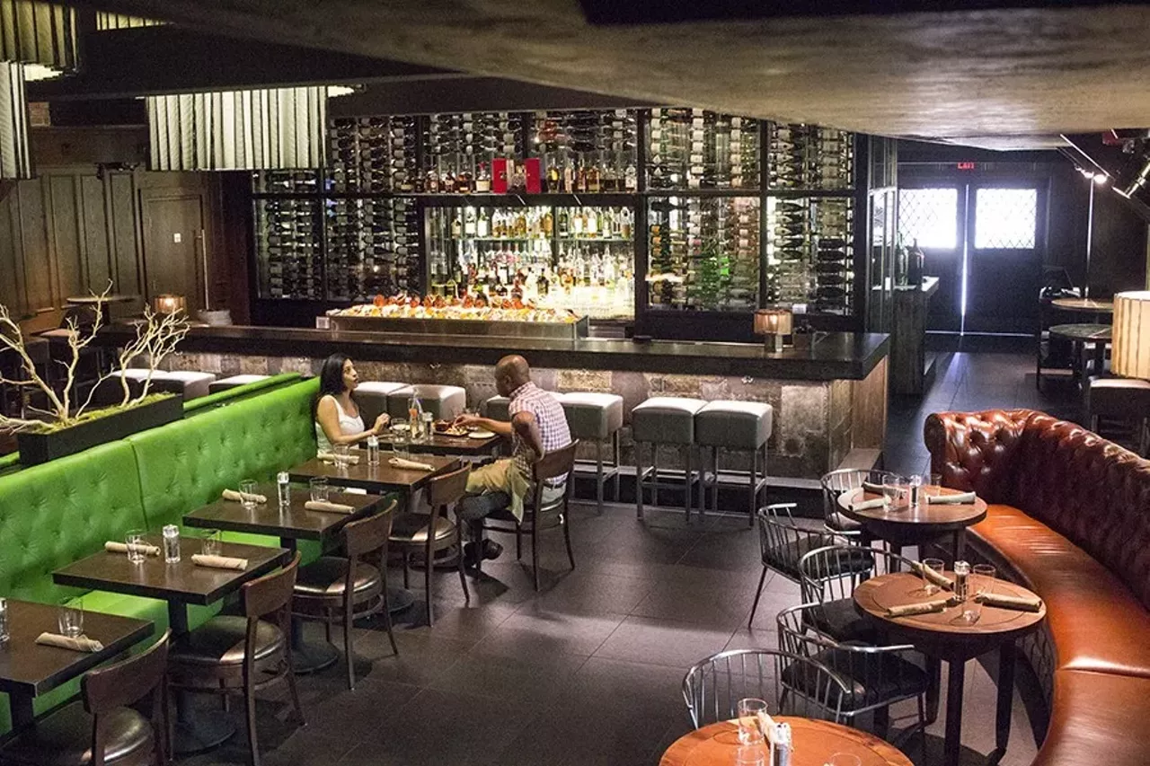 Boundary (7036 Clayton Avenue; 314-932-7818) "Boundary is a make-under of the former Basso space, though you'd never guess that by looking at it. The room is strikingly handsome and sultry &#151; the kind of place you'd find James Bond sipping a martini after a day of fox hunting. The signature glass wine wall is still there, but instead of separating the bar from the dining room, the bar now wraps around it, while the room's former vibrant red tones have been muted in favor of dark wood and leather. Booth seating has been replaced with semicircle banquettes that face outward, and an eye-popping kelly green leather double-sided couch adds two rows of seating in the middle of the room." - Cheryl Baehr Photo credit: Mabel Suen