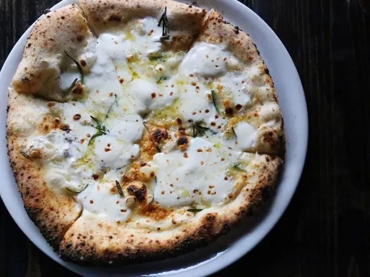 This pizza from Pizzeoli Wood Fired Pizza Napoletana (1928 S. 12th St., 314-449-1111) includes bechamel sauce, extra virgin olive oil, fresh mozzarella, garlic, rosemary and parmesan. Photo courtesy of Instagram/ feedme_withamanda.