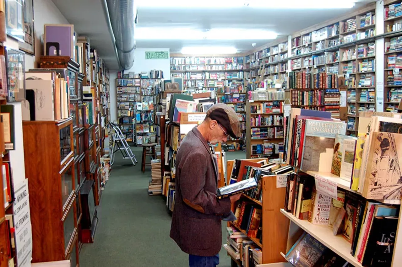 Chris Costley reads one of the shop's many books. Another bonus of The Book House, besides the variety? A portion of the Book House's profits benefit the Foster and Adoptive Care Coalition and Second Chapter Life Center for young adults with special needs.