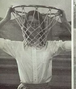 Jane Smiley's high school yearbook photo. In Lucky, Jodie recalls of a classmate, "The gawky girl had stuck her head into a basketball basket, taken hold of the rim, and her caption was, 'They always have the tall girls guard the basket.'" - VIA THE SCHOOL YEARBOOK