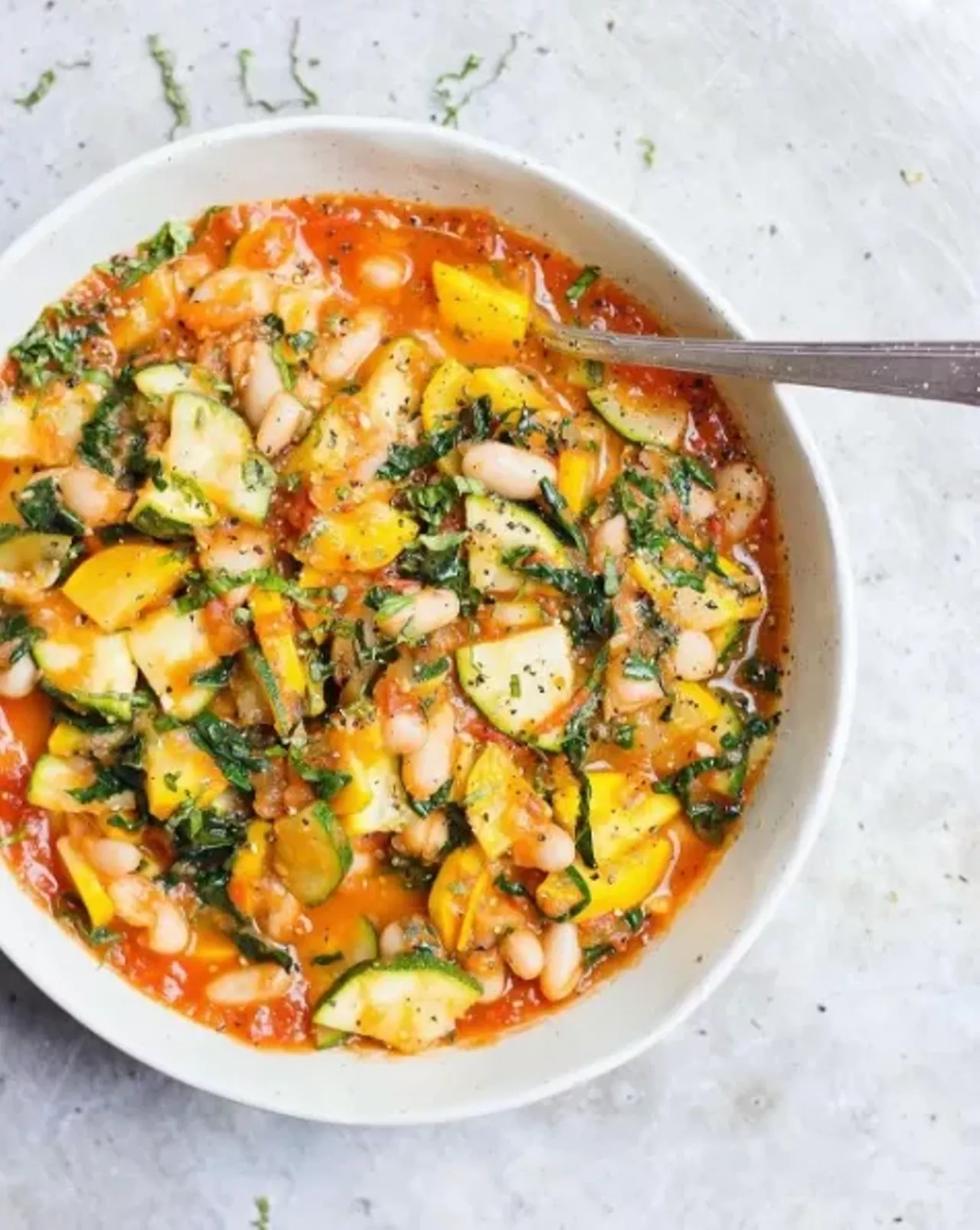 Quick-stewed zucchini and white beans with fresh tomato sauce. Photo courtesy of Instagram / withfoodandlove.