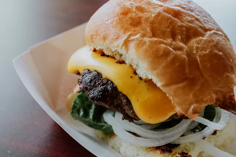 The "Hank Burger," cooked on a vintage grill right behind the bar, is Iowa Buffet's signature dish. - Phuong Bui