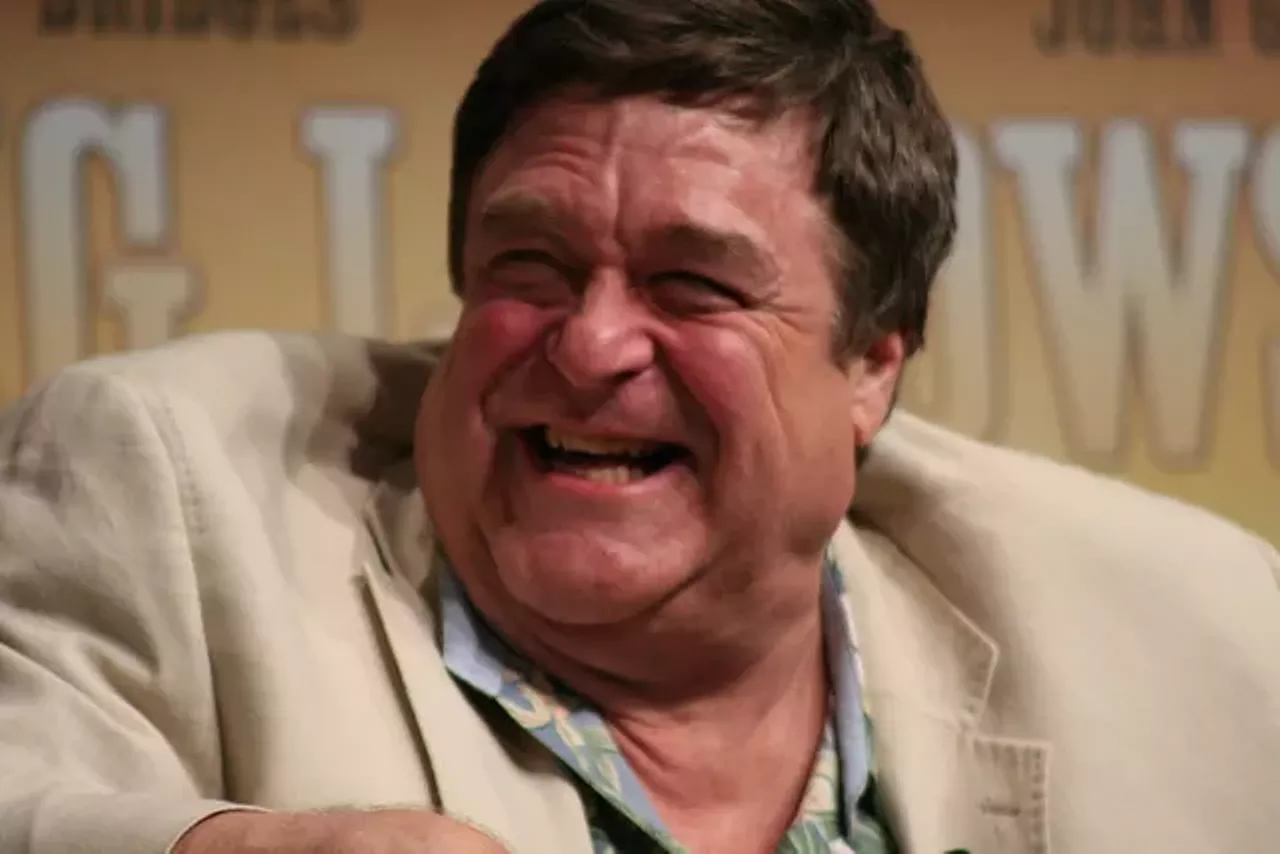 John Goodman He's thought of as Dan Connor from Lanford, Illinois, but John Goodman's distinctive Midwestern accent on Roseanne came from growing up in St. Louis. Goodman is from Affton and went to Affton High School before earning a football scholarship to Missouri State University. Photo credit: Jack polletta / Flickr